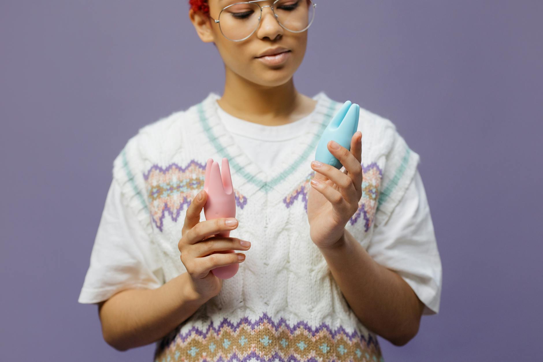 Woman holding lemon vibrators in contemplative pose, representing options for sensitive pleasure